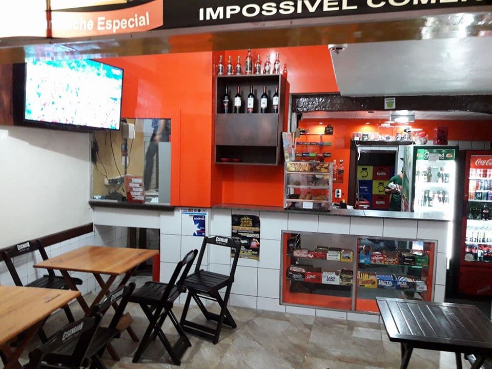 A gastronomia mineira popular com opções de lanches e bebidas diversas em salão modesto com mesinhas e balcão.