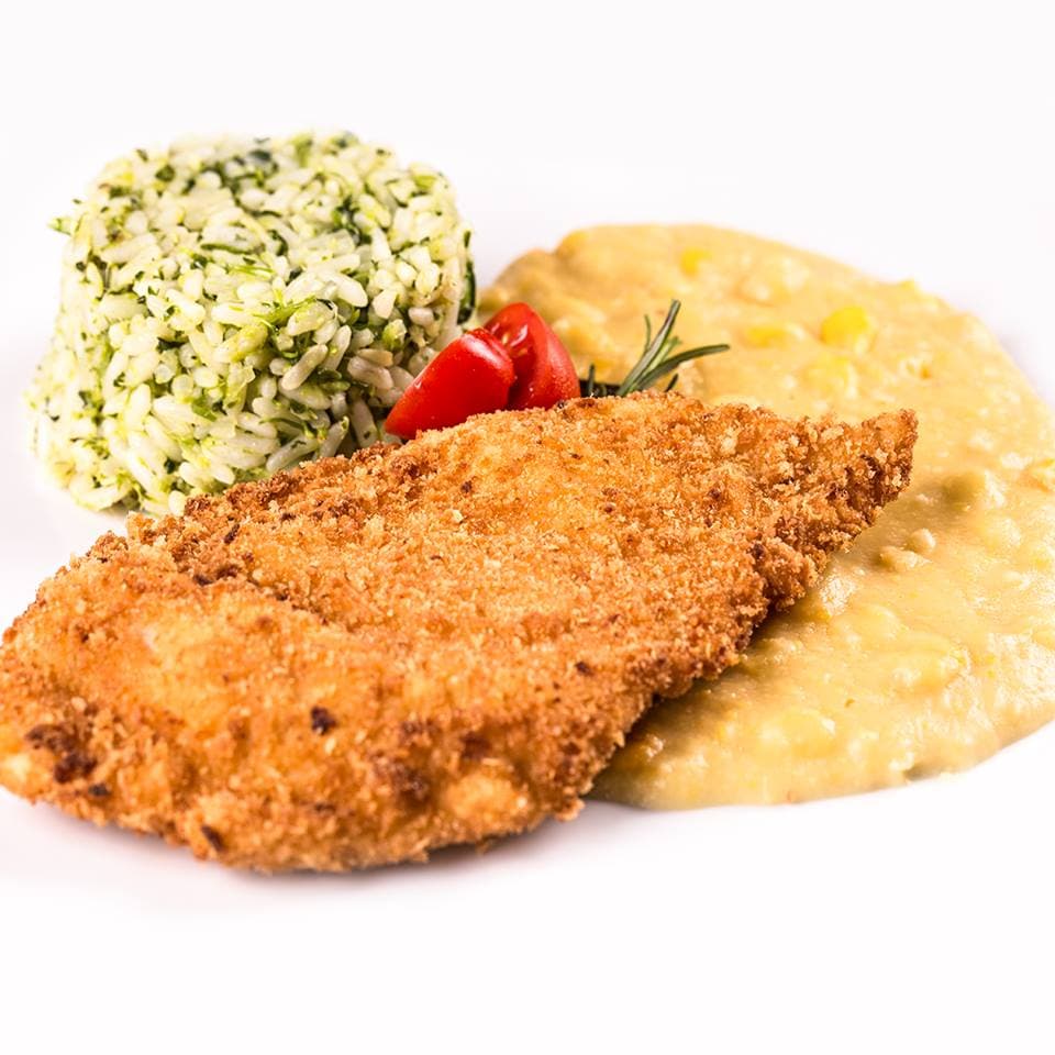 Comidas diversificadas servidas com estilo em um local arborizado que transmite aconchego e sofisticação.